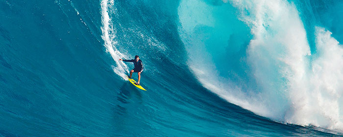 a surfer riding a huge wave