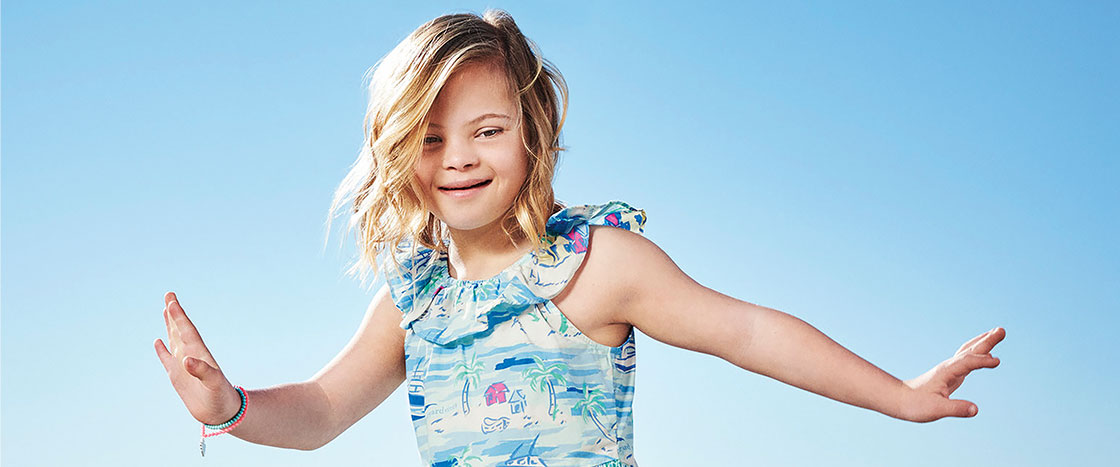 a young girl smiles at the camera