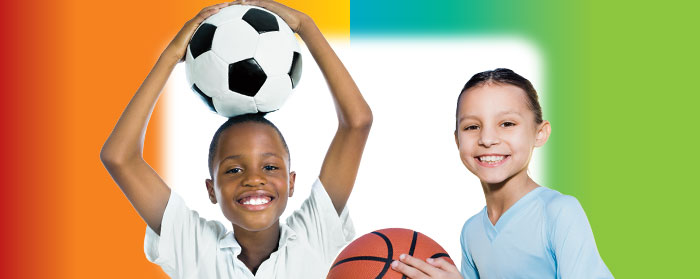 a boy holding a basketball next to a girl holding a soccer ball