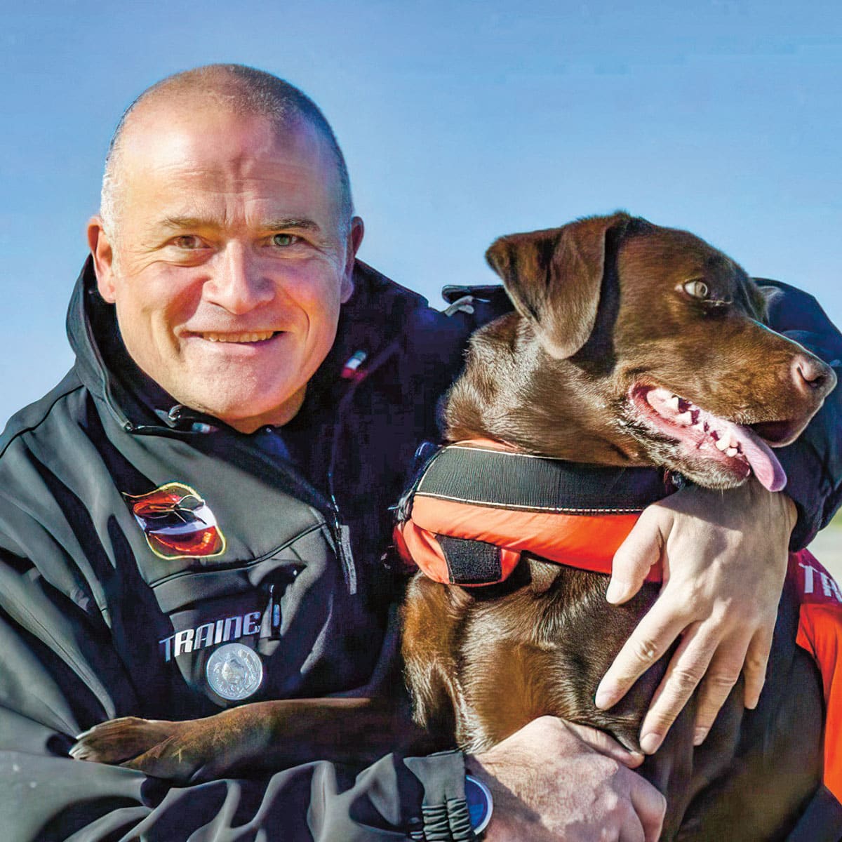 a man hugging a dog