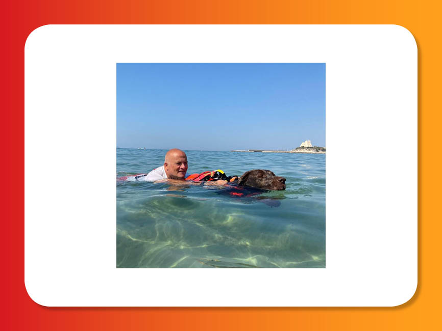 a man and dog swimming