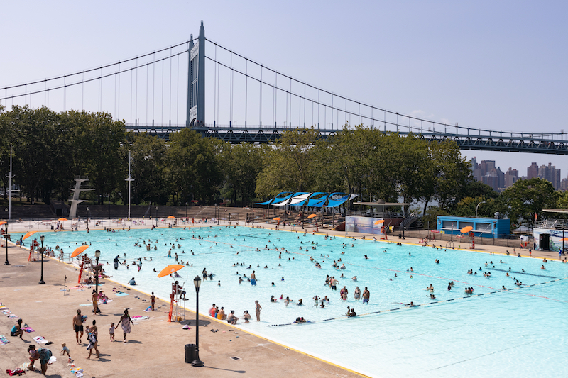 a large group of people gather in a big pool