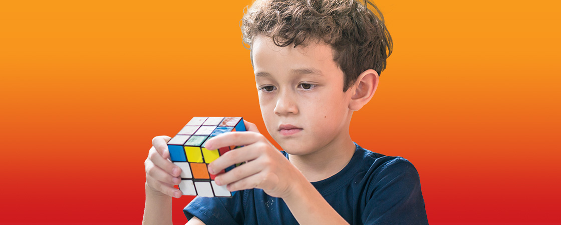 Image of a kid solving a rubik&apos;s cube