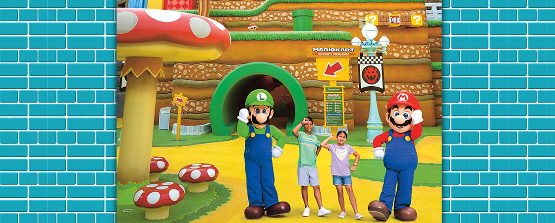 Image of two kids posing with Luigi and Mario in Super Mario world