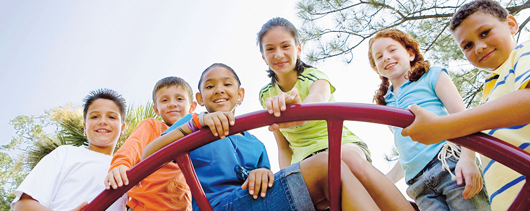 Smiling children on a monkey bar